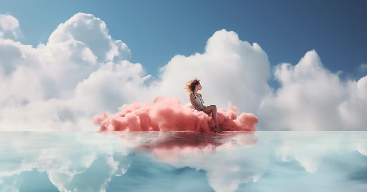 A surreal photo of a woman in complete bliss and relaxing on a pink cloud floating on the crystal blue water.